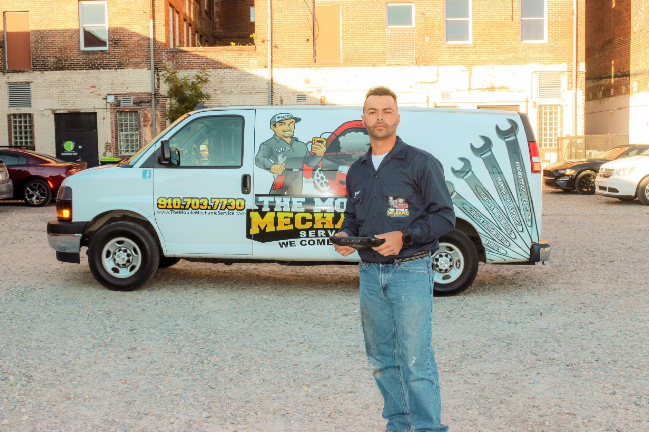 Avern Collins standing in front of the branded Mobile Mechanic Service van
